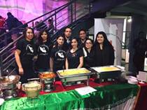 Image may contain: 8 people, people smiling, people standing and indoor